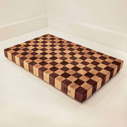 Wooden cutting board with checkered pattern on a white surface
