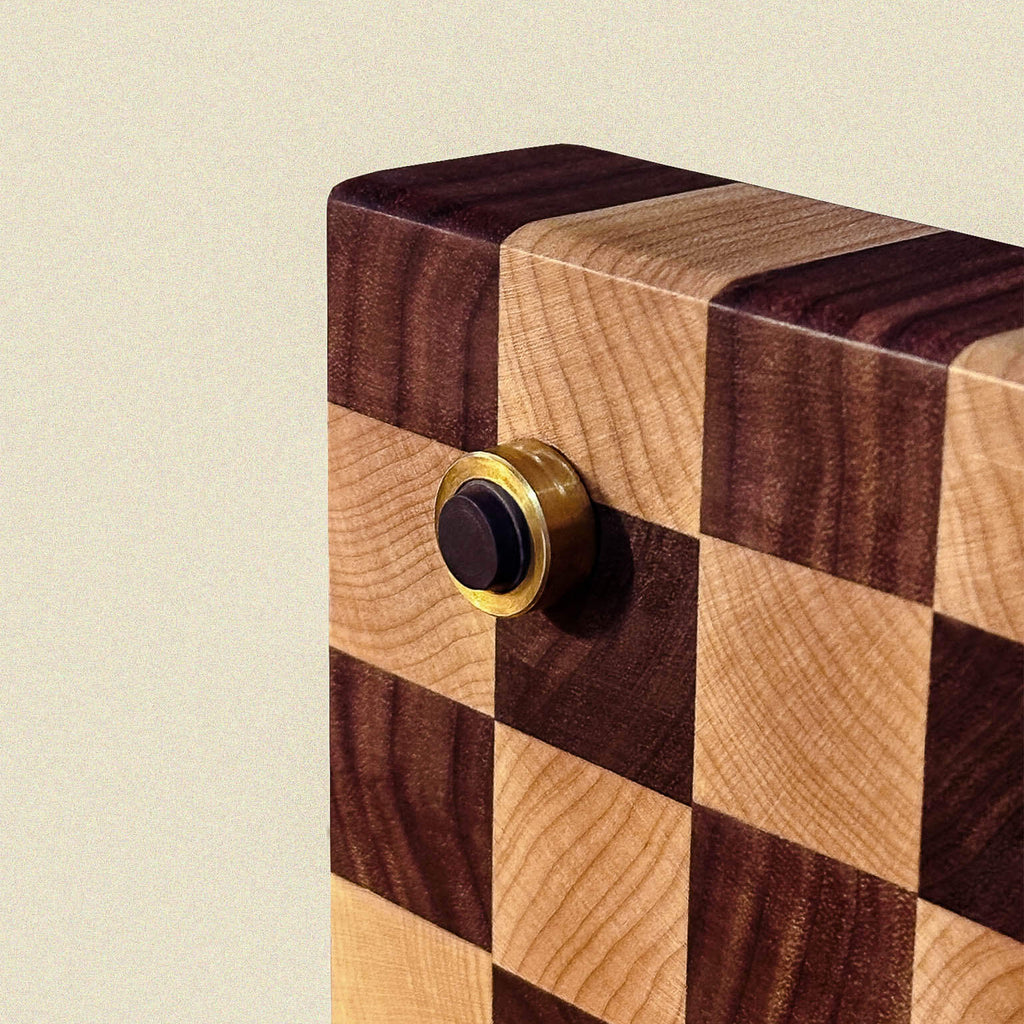 Wooden board with checkered pattern and brass non-slip feet